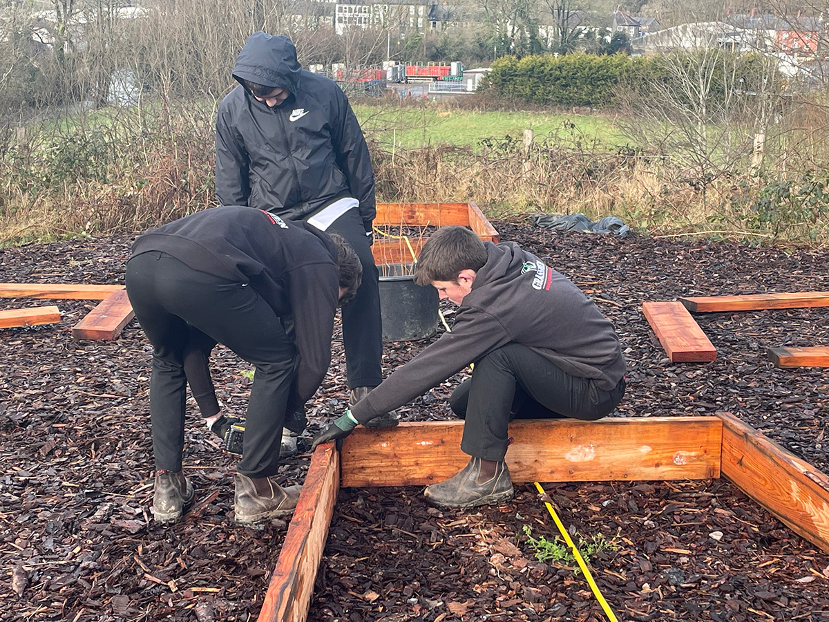 Students building a raised bed.